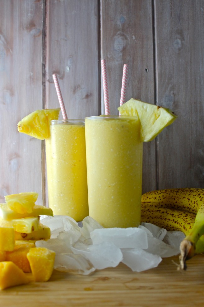 This Tropical Fruit Smoothie - with lots of pineapple, mango, and rich coconut milk - is fruity, frosty, tart, and creamy! | The Millennial Cook #winterrecipe #smoothie #orange #banana #mango #pineapple #coconut