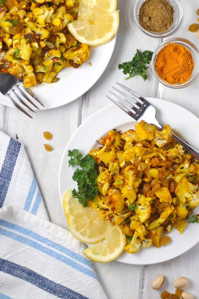 This Turmeric Roasted Cauliflower Salad is a light and tasty dish filled with roasted cauliflower, turmeric, cumin, golden raisins, and bright lemon juice| The Millennial Cook #salad #cauliflower #turmeric