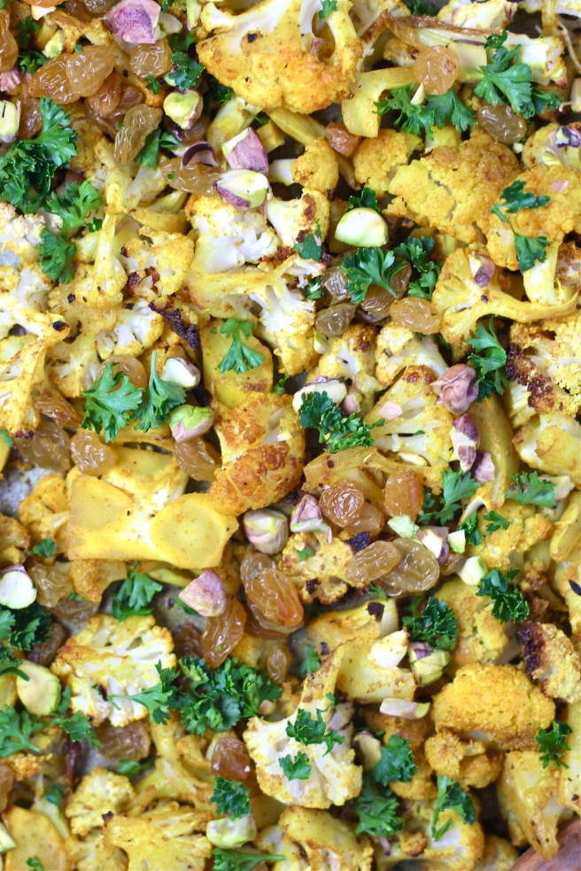 This Turmeric Roasted Cauliflower Salad is a light and tasty dish filled with roasted cauliflower, turmeric, cumin, golden raisins, and bright lemon juice| The Millennial Cook #salad #cauliflower #turmeric
