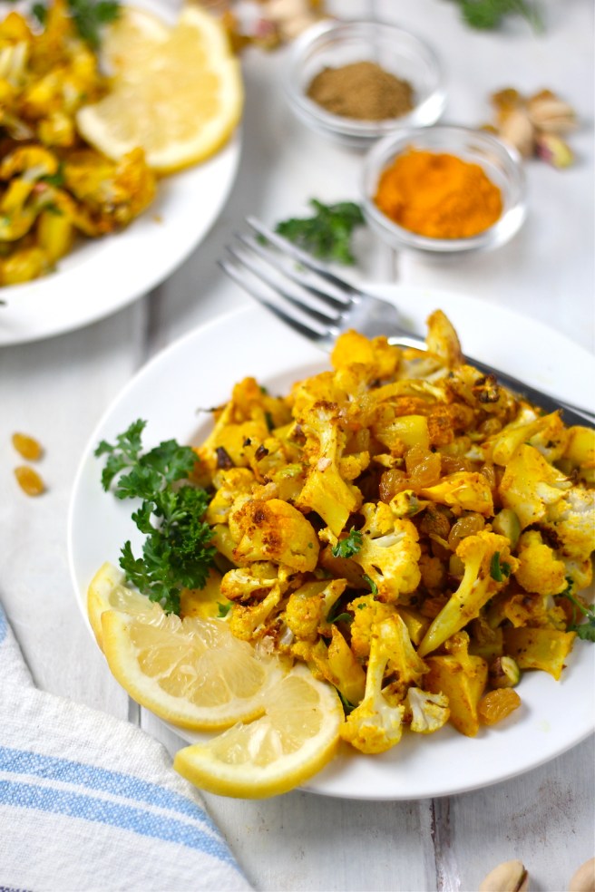 This Turmeric Roasted Cauliflower Salad is a light and tasty dish filled with roasted cauliflower, turmeric, cumin, golden raisins, and bright lemon juice| The Millennial Cook #salad #cauliflower #turmeric